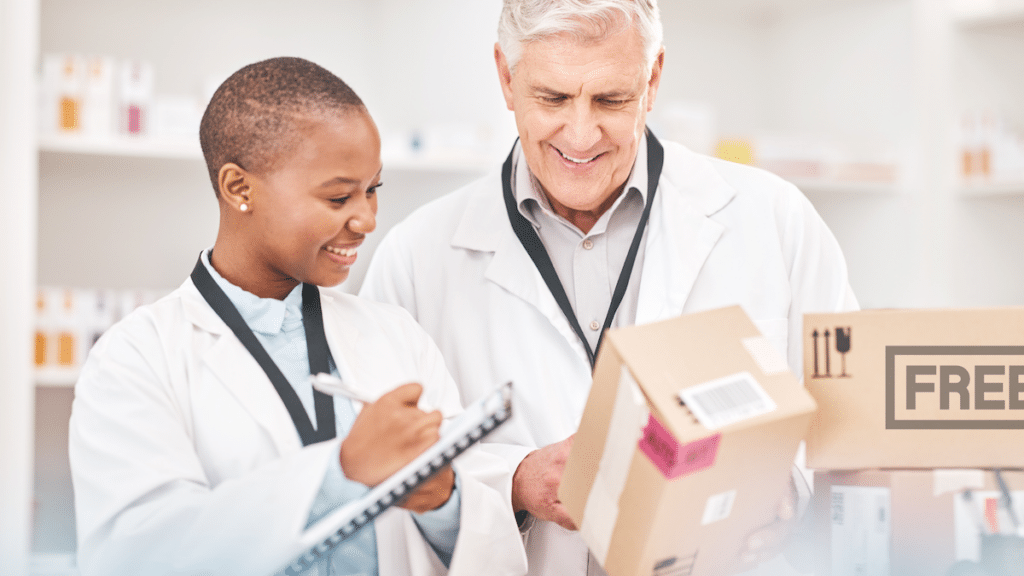Two pharmacists reviewing a free package in a pharmacy.