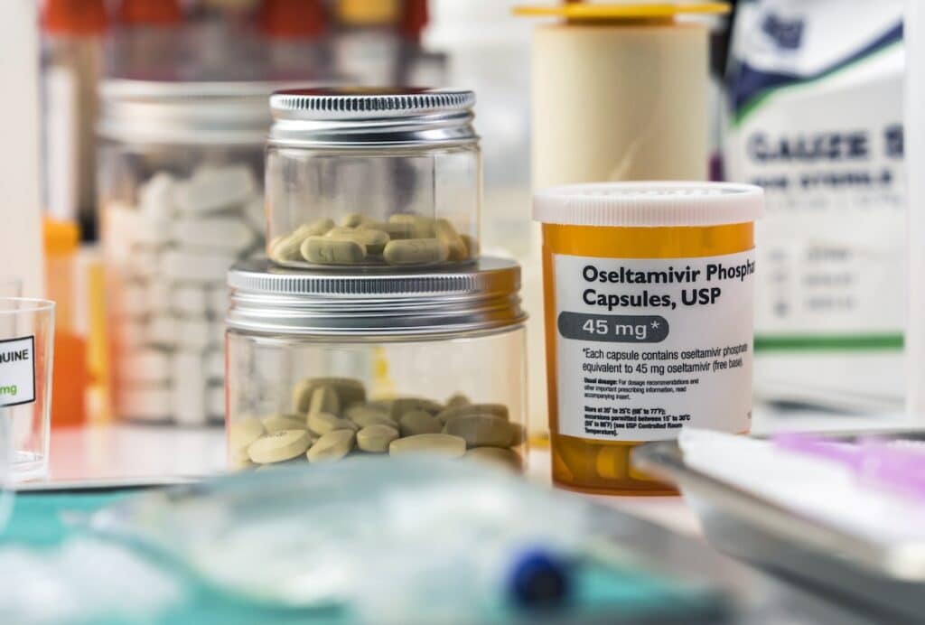 Different medication prepared for people affected by Covid-19, Oseltamivir is a selective antiviral prophylactic against virus, unbranded generic drug containers and hypothetical bar codes, conceptual image